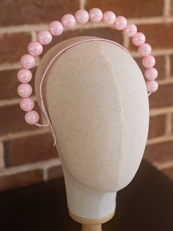 Side view of pink beaded headband.