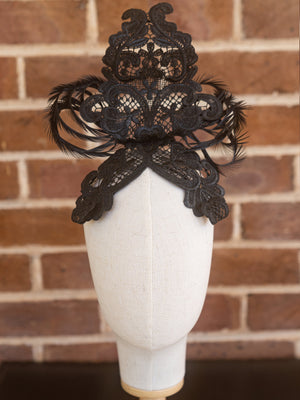 Front view of black lace headpiece.