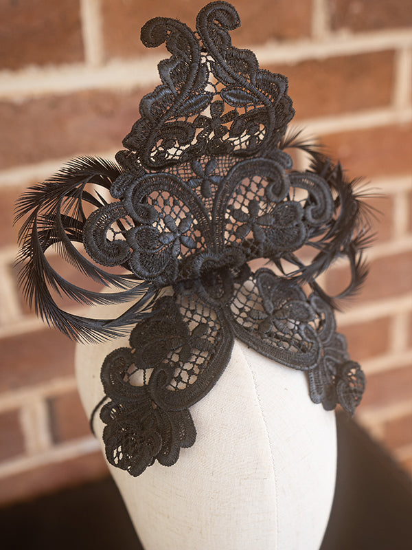 Close up of black lace headpiece.