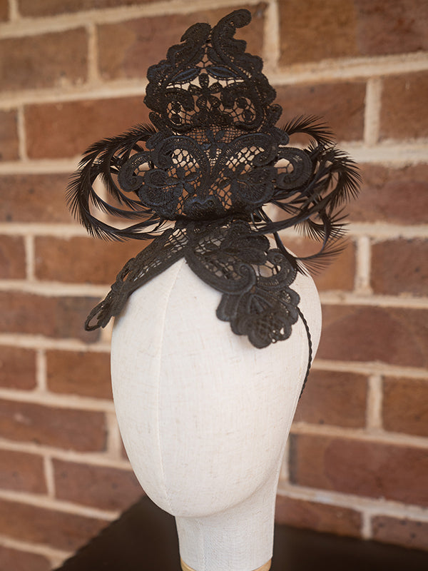 Side view of black lace headpiece.