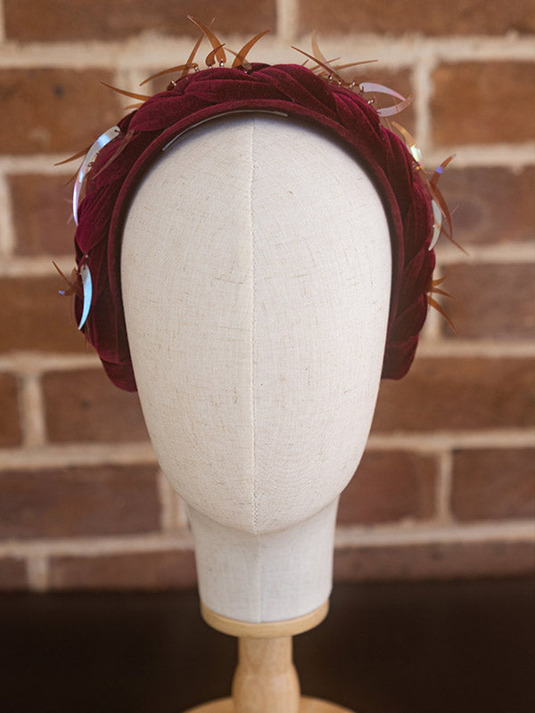 Front view of crimson velvet headpiece.