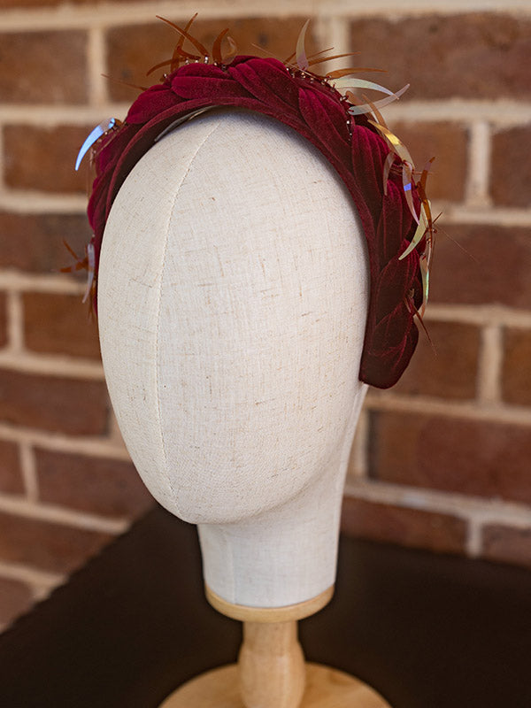 Side view of crimson velvet headpiece.