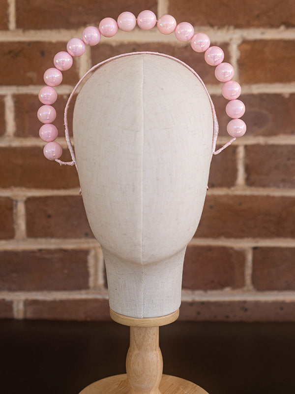 Front view of pink beaded headband.