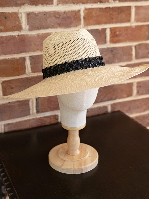 Side view of the wide brimmed natural panama hat.